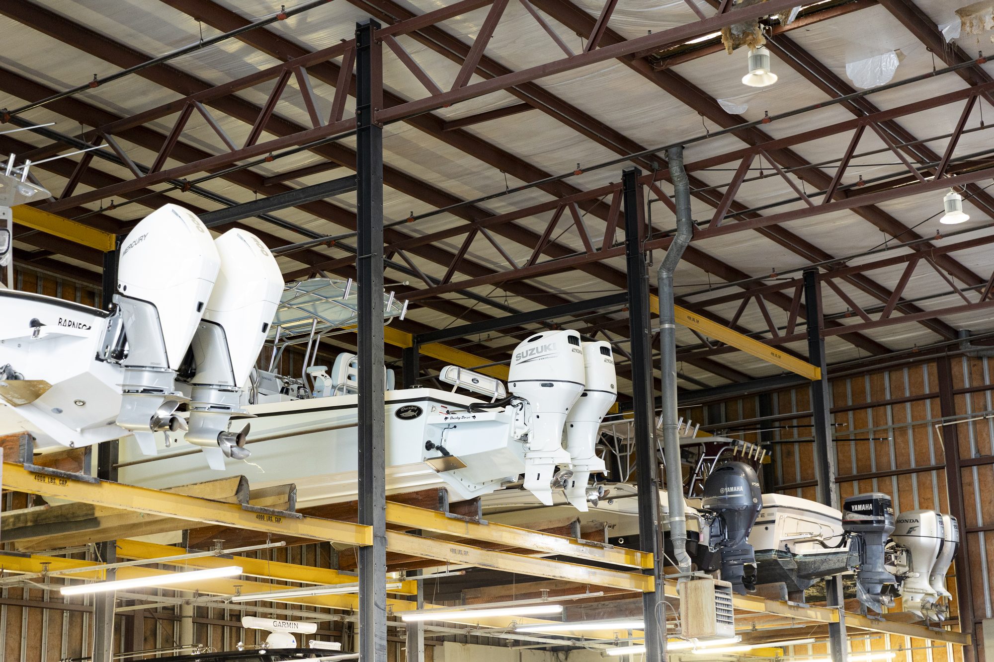 Indoor Dry Stack Boat Storage Center console boats stored on racks inside the covered dry stack building at Key Harbor Marina