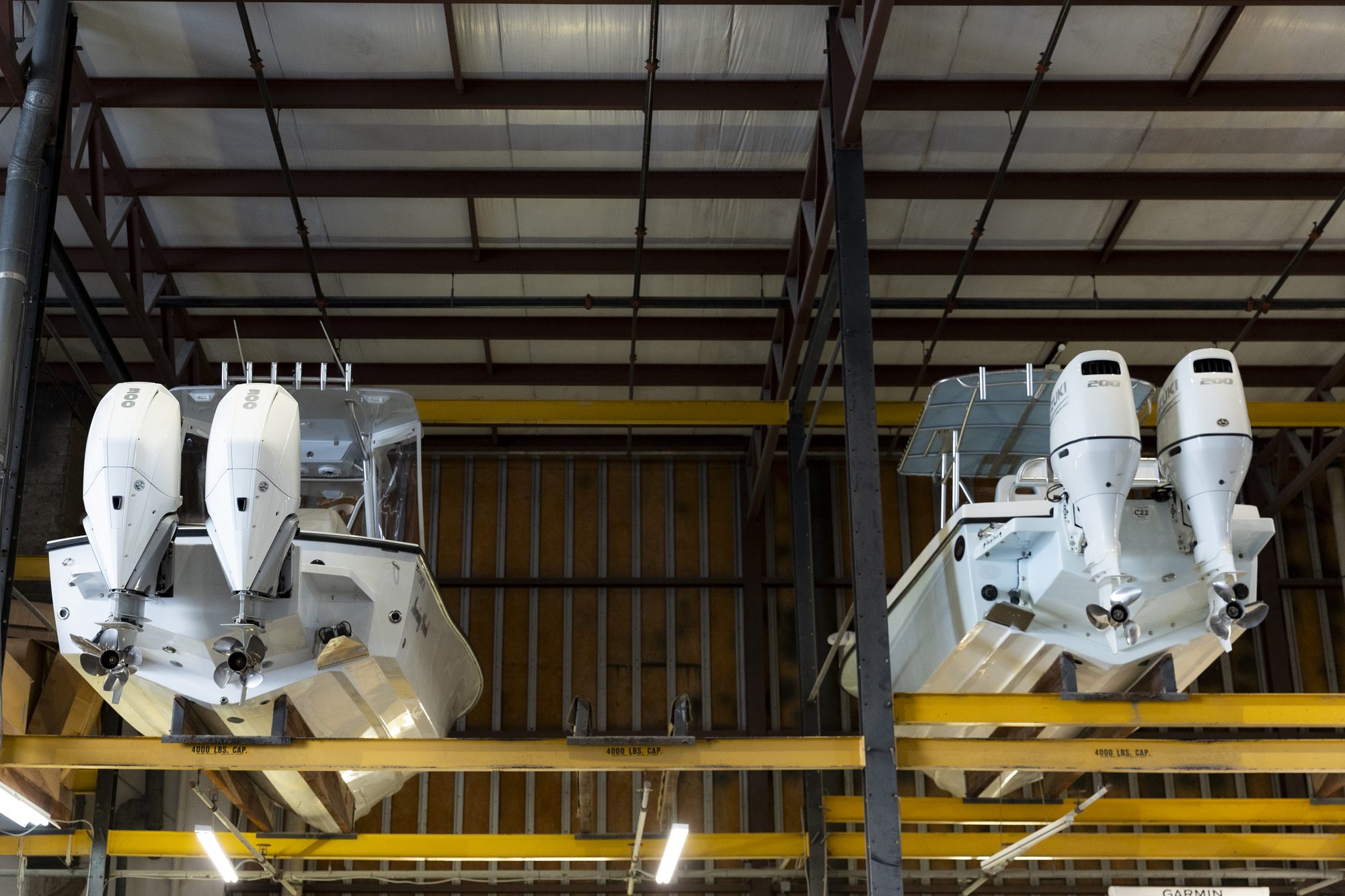 Dry Stack Storage Racks Two outboard-powered boats racked on upper levels of indoor dry stack storage at Key Harbor Marina