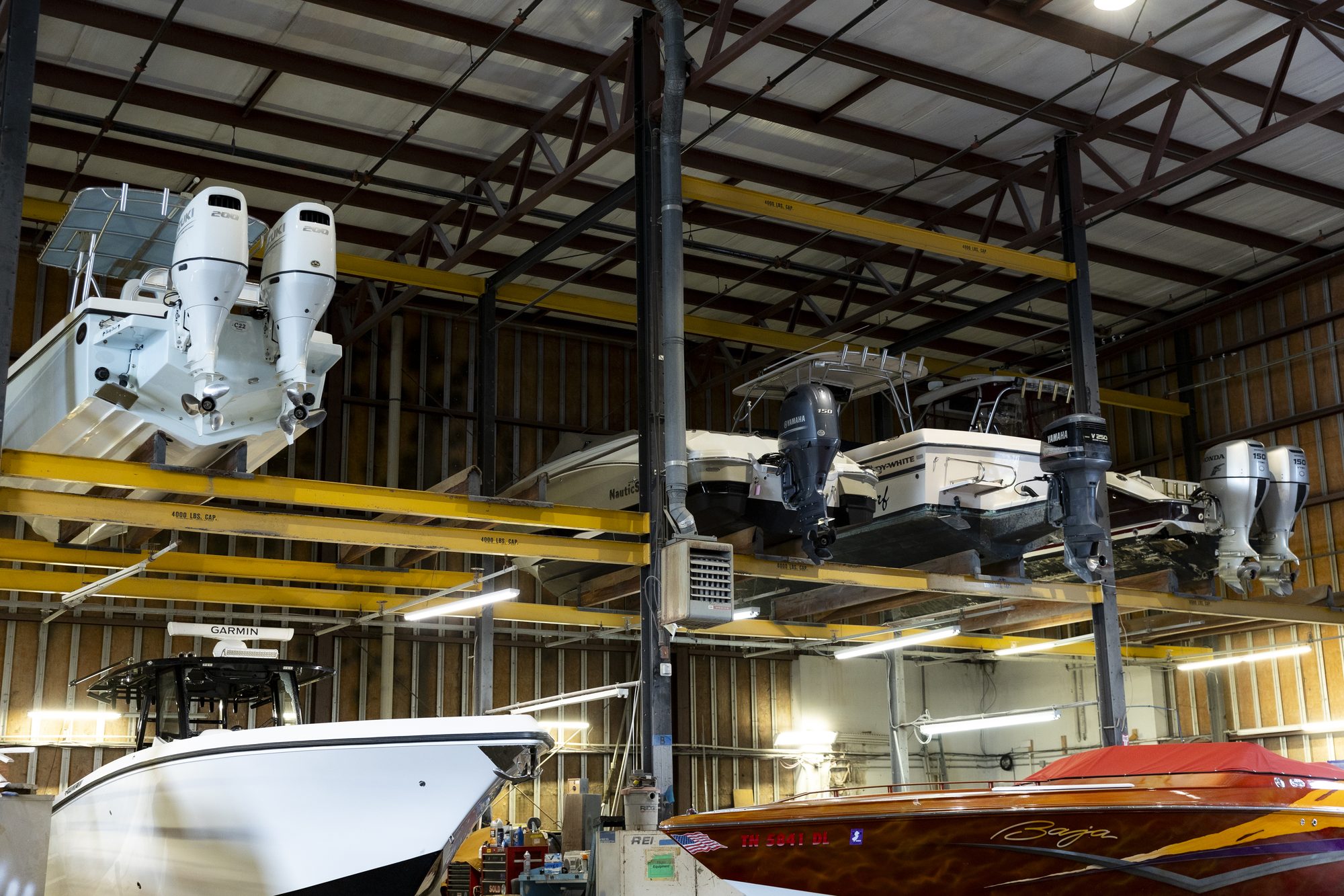 Covered Boat Storage Facility Multiple boats stored on racks inside the climate-protected storage building at Key Harbor Marina